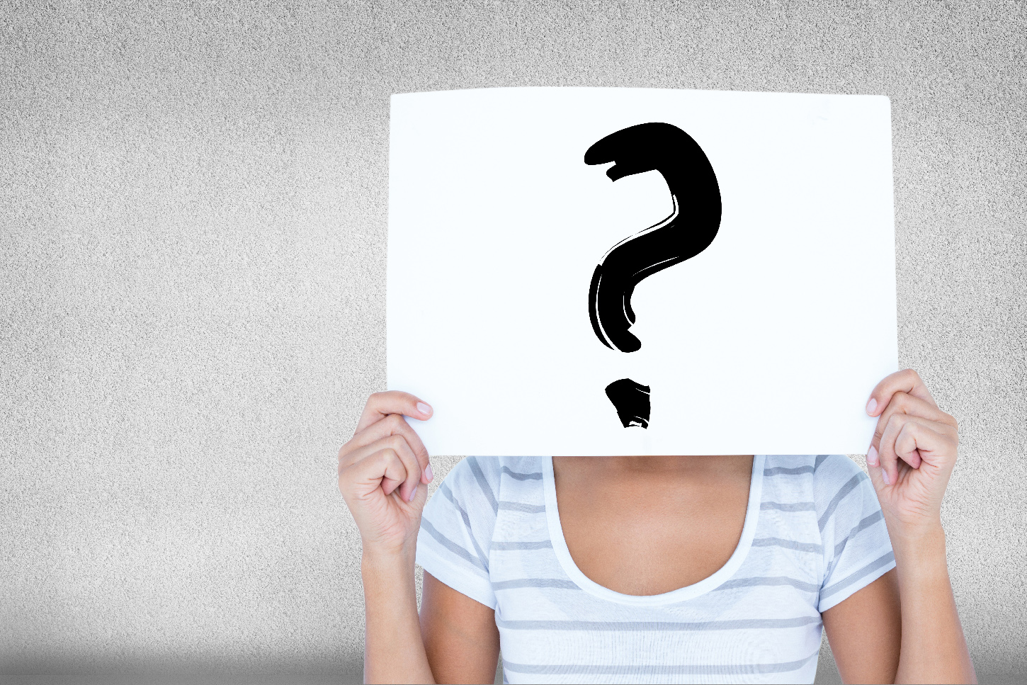 Signo de interrogación pintado en un cartel que sostiene una mujer a la altura de su cara